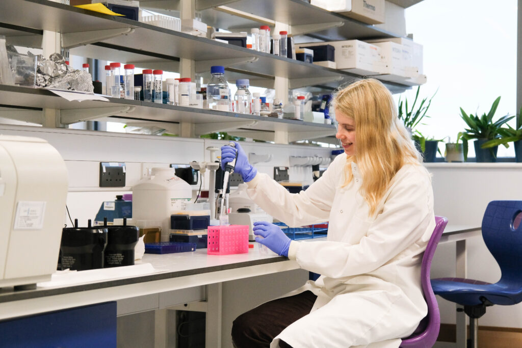 A female PhD student in a laboratory conducting experiments.
